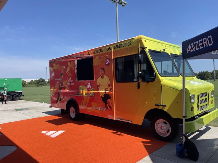 A brightly branded Adidas activation food truck at a Florida event