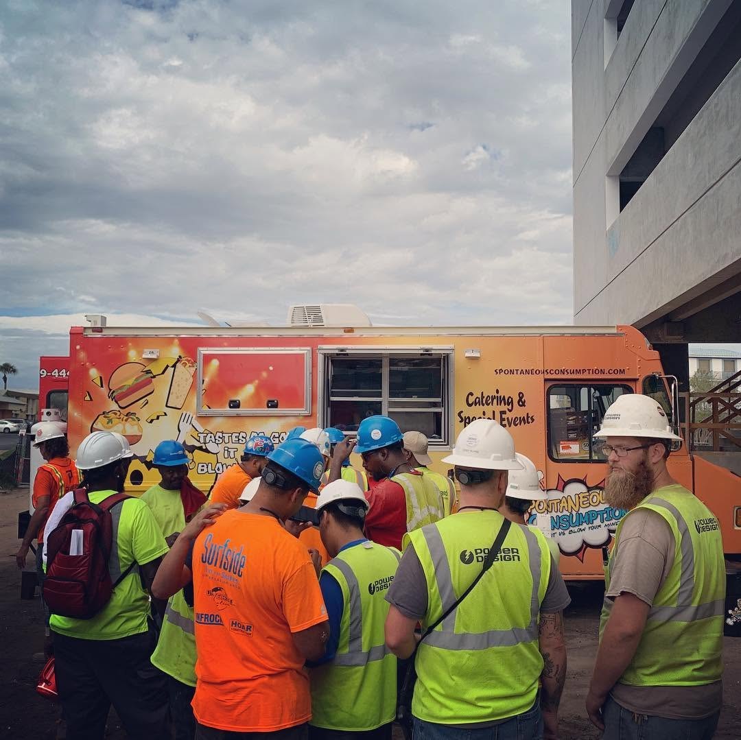 Food truck crew in hi-vis vests serving at a Florida event