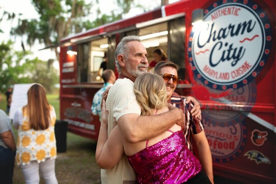 Hosts greeting a food truck crew on arrival at a Florida event