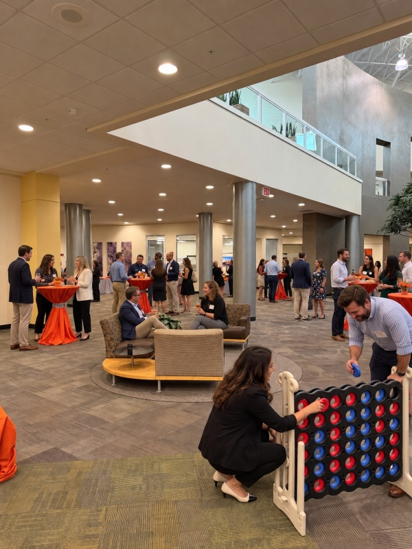 Corporate networking reception with cocktail tables and a giant Connect Four game